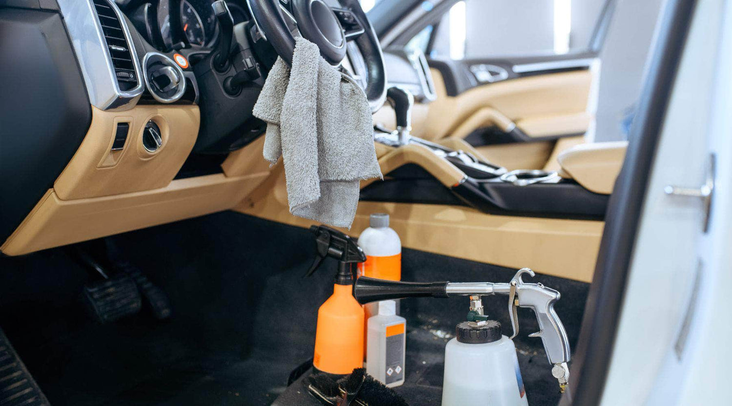 Interior of a car being professionally detailed, featuring cleaning tools and products by Martin Auto Detailing in Dallas, TX.